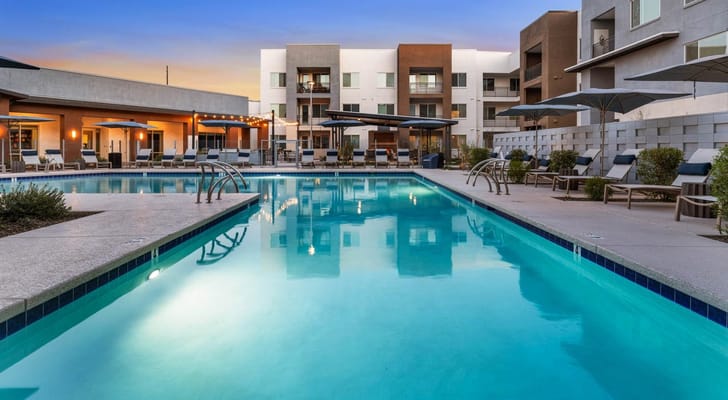 Swimming pool area with lounge chairs and umbrellas