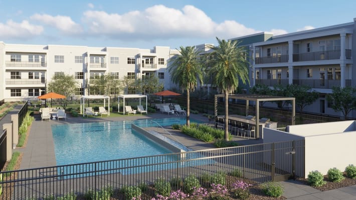 A beautiful outdoor pool area with palm trees and lounge chairs