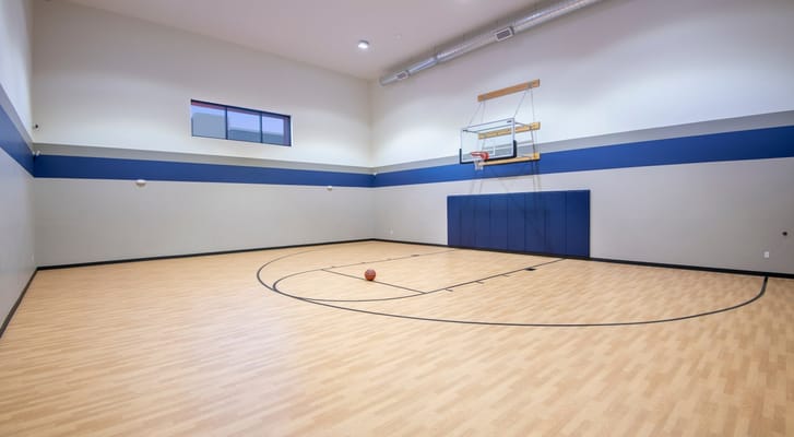 Empty basketball court with a hoop and a basketball