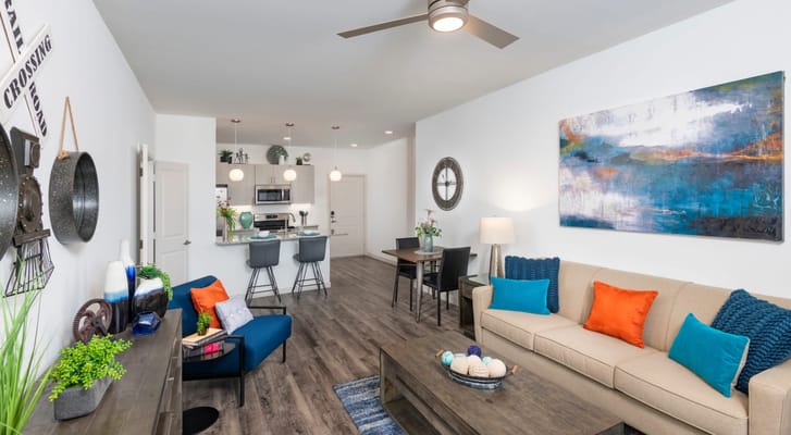Spacious living room with modern decor and kitchen