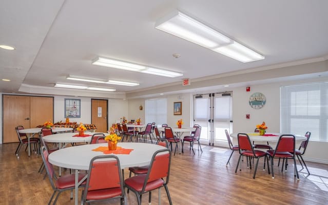 Bright common area with tables set for dining
