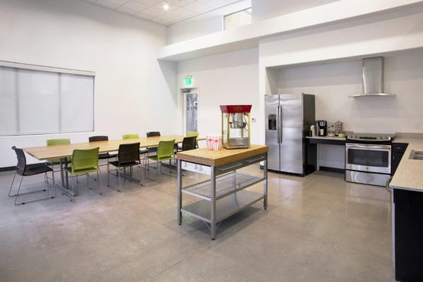Bright kitchen and dining area with tables and chairs
