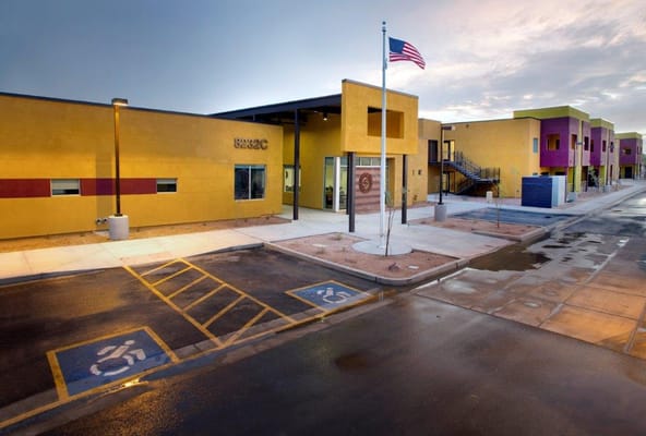 Vibrant exterior view of Landmark Senior Housing facility with American flag.