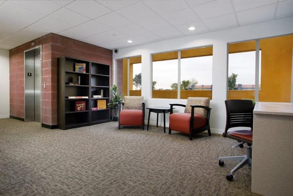 Comfortable seating area with a bookshelf and windows