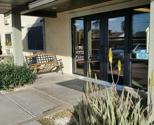 Entrance area with bench and plants outside