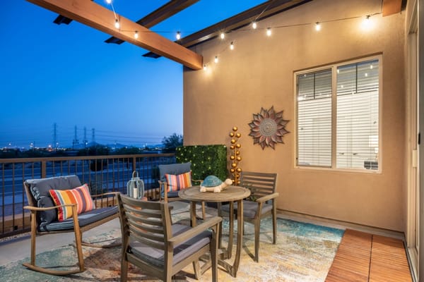 Stylish balcony with seating and decorative elements in evening light