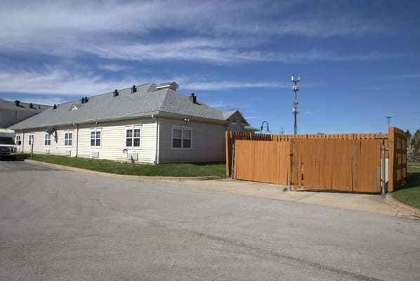 Exterior view of a senior living facility with a gated entrance
