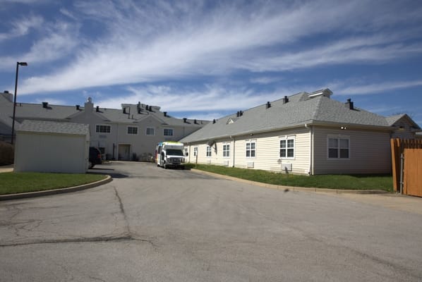 Exterior view of the facility with parked vehicles