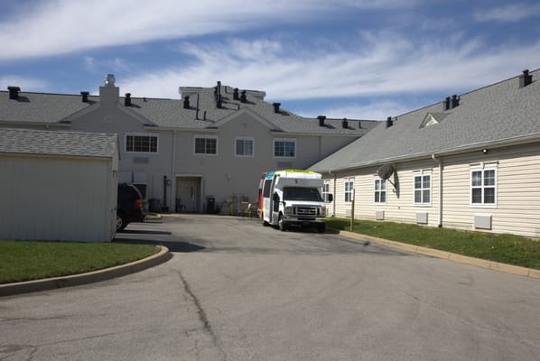 View of the facility's parking area with a transport vehicle