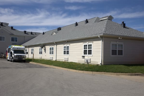 Exterior view of the facility with a transport van