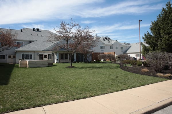Exterior view of assisted living facility with green lawn