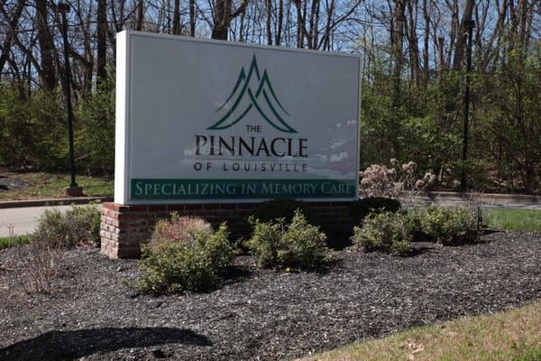 Sign for The Pinnacle of Louisville specializing in memory care