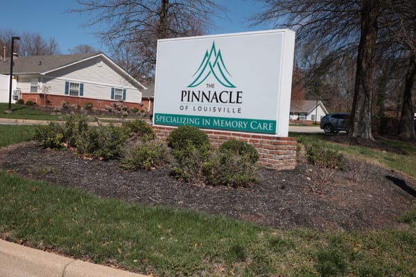 Sign for The Pinnacle of Louisville specializing in memory care