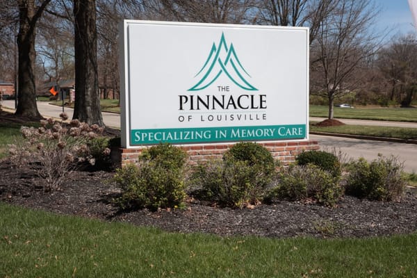 Sign for The Pinnacle of Louisville specializing in memory care
