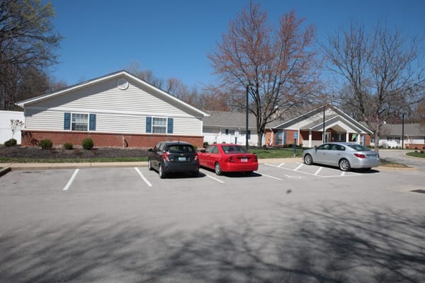 Parking area with several cars outside The Pinnacle of Louisville