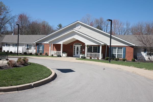 Exterior view of The Pinnacle of Louisville entrance with a landscaped pathway.