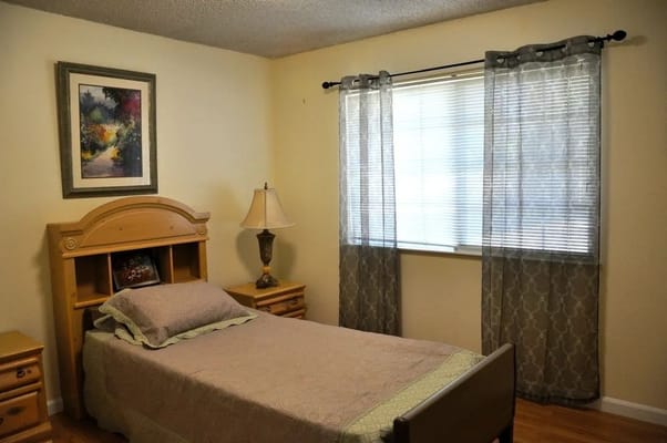 Interior view of a private resident room with a single bed