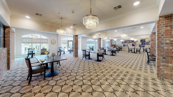 Bright dining room with tables and chandelier lighting