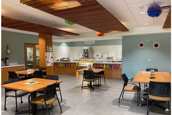 Inside view of a dining area with tables and food service