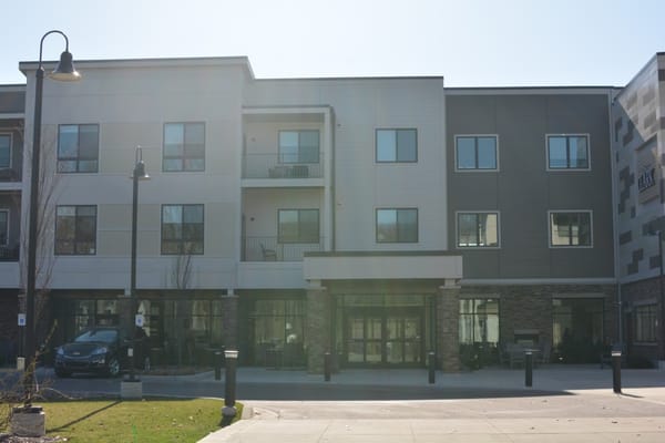 Exterior view of Clark Retirement facility with parking area