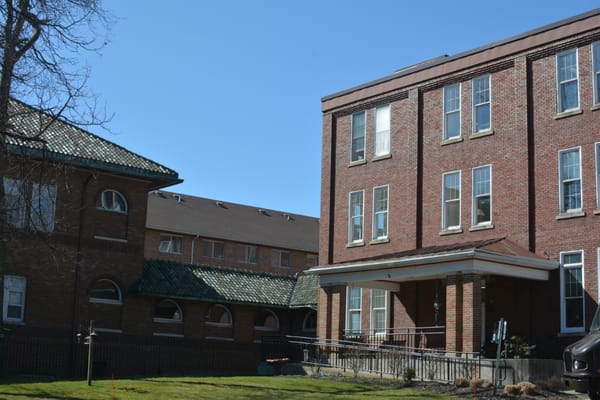 Facade of Villa Maria Retirement Community showing two brick buildings
