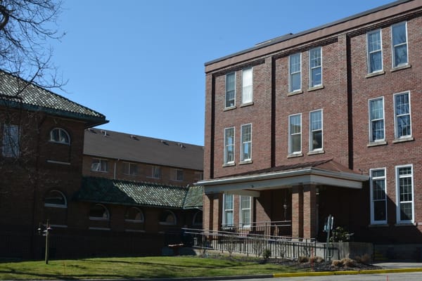 Front entrance view of Villa Maria Retirement Community with brick facade.
