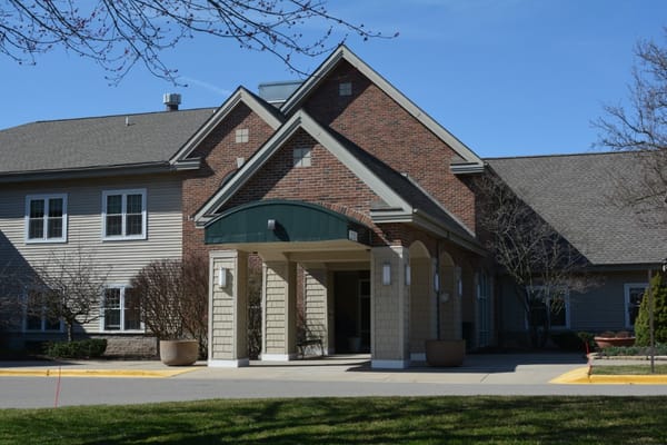 Entrance of a senior living facility with outdoor landscaping