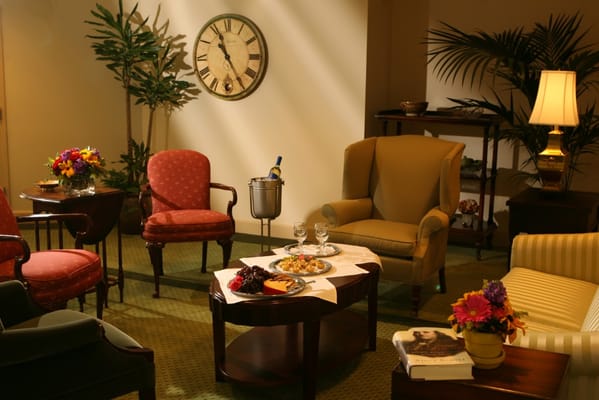 Comfortable lounge area with refreshments and flowers