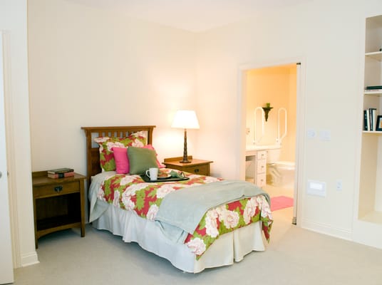 Cozy resident bedroom with floral bedding and a lamp