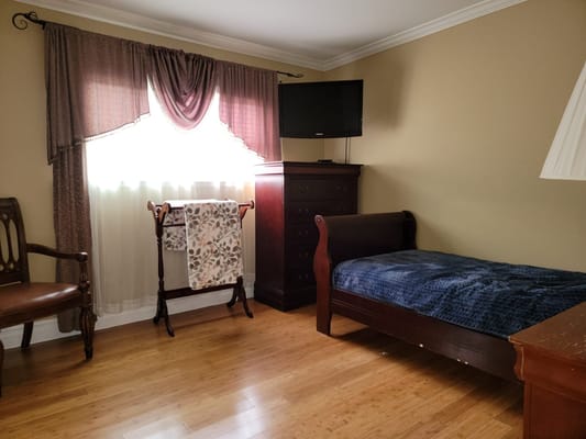 Cozy resident room with a bed and chair