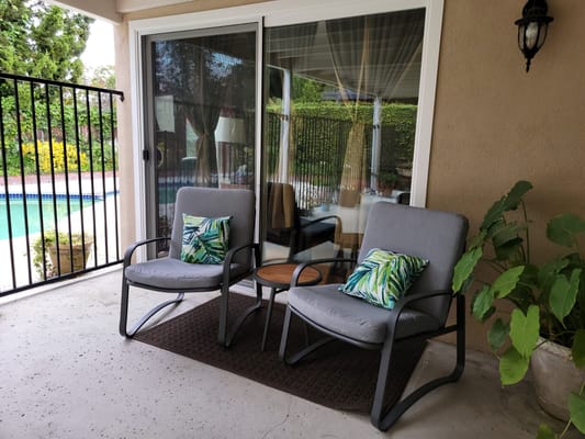 Outdoor seating area with pool view