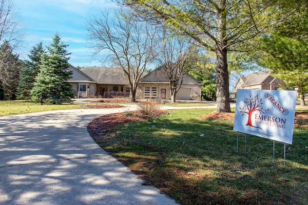 Front entrance of Emerson Senior Living with signage and landscaping