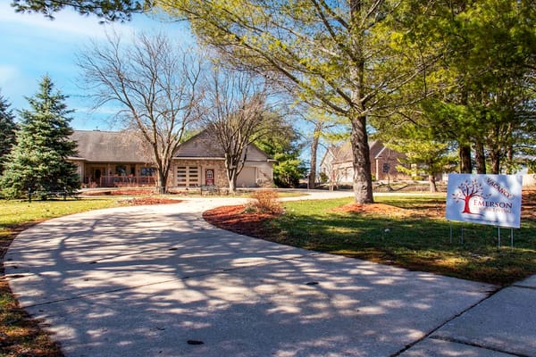 Pathway leading to Emerson Senior Living with a sign indicating vacancy.