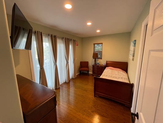 Cozy resident room with natural light and wooden furniture