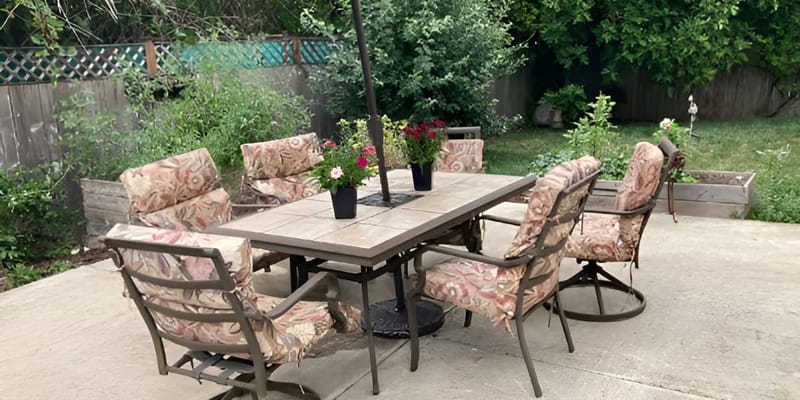 Outdoor dining area with chairs and flower pots