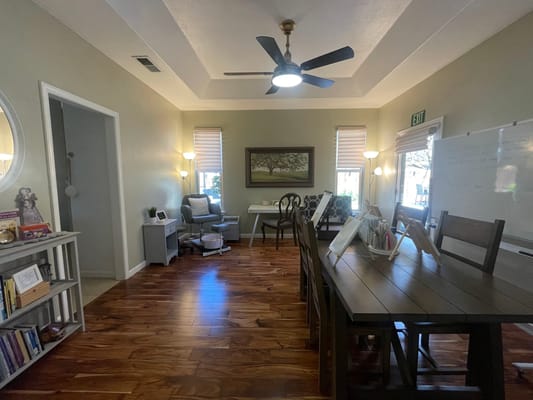 Interior view of a bright common area with wood flooring