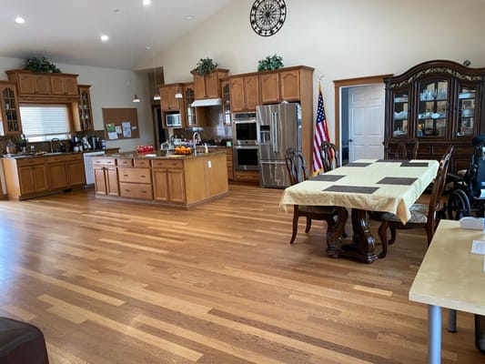A spacious kitchen and dining area with wooden cabinetry and a large dining table.