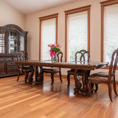 Elegant dining room with a wooden table and chairs, flower vase in center