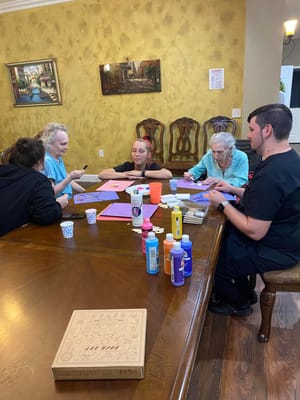 Residents and staff engaged in an arts and crafts activity