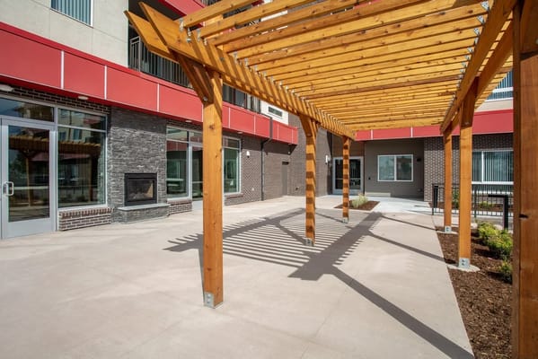 Outdoor pergola with seating area at senior living facility