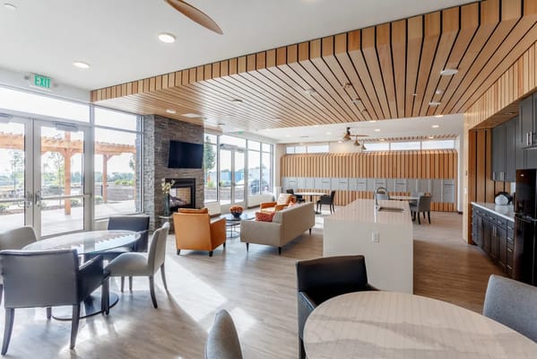 Bright common area with seating and large windows