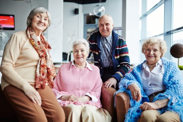 Four residents sitting together in a common area
