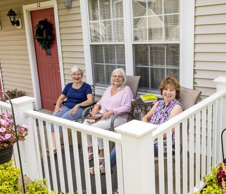 Three residents enjoying time on a porch