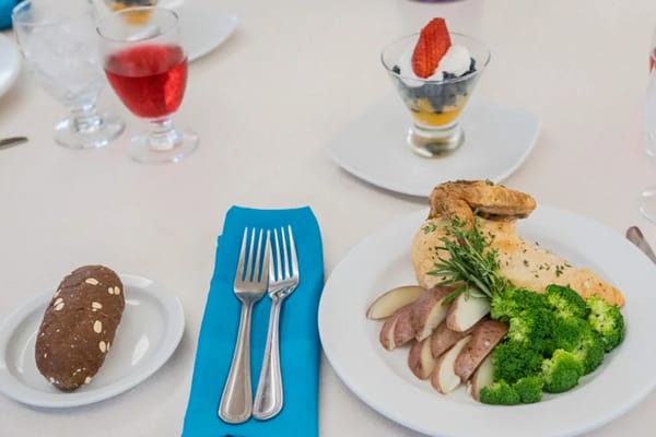 A plated meal on a dining table with drinks