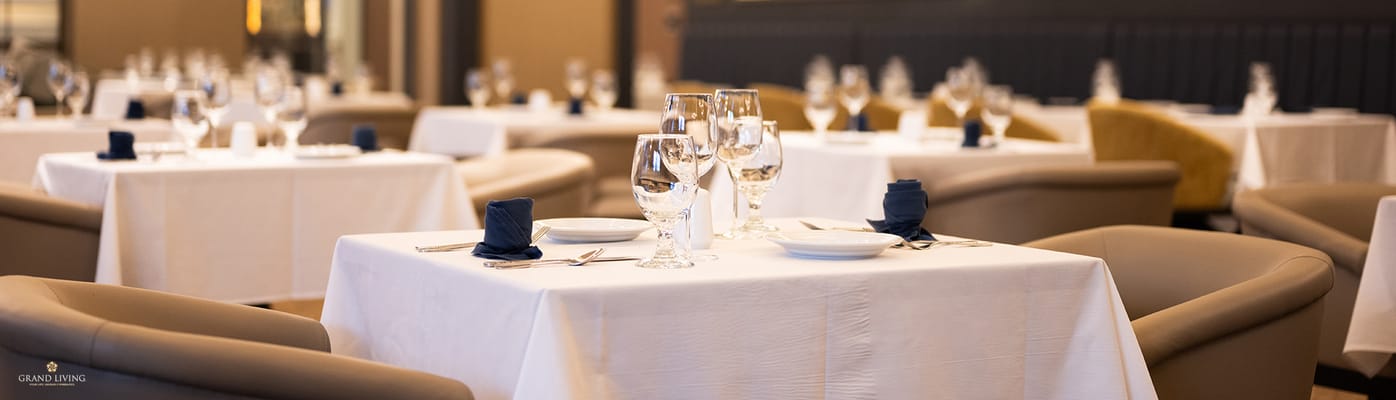 Elegant dining room setup with tables and glassware