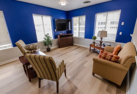Bright common area with seating and television