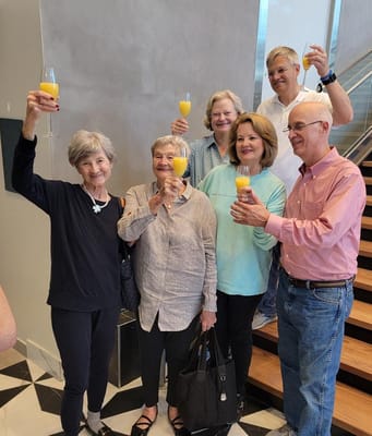 Group of residents celebrating with drinks in a common area