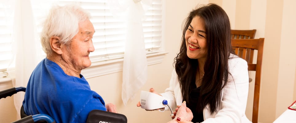 Caregiver assisting a resident in a bright room