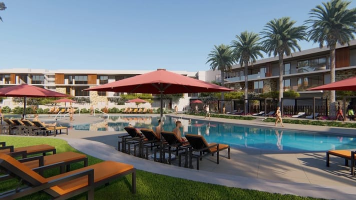 Swimming pool area with loungers and umbrellas