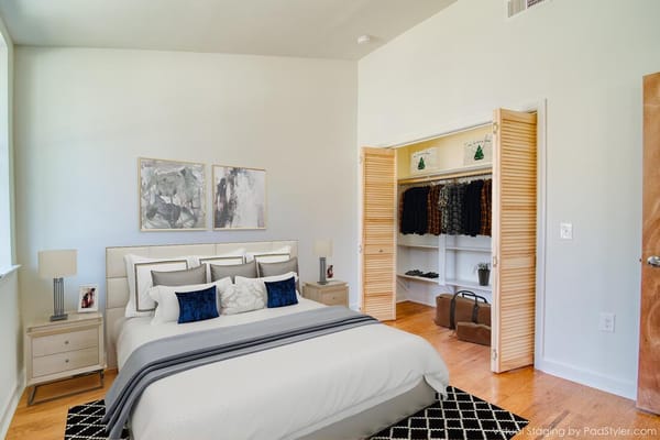 Neatly arranged bedroom with light colors and organized closet